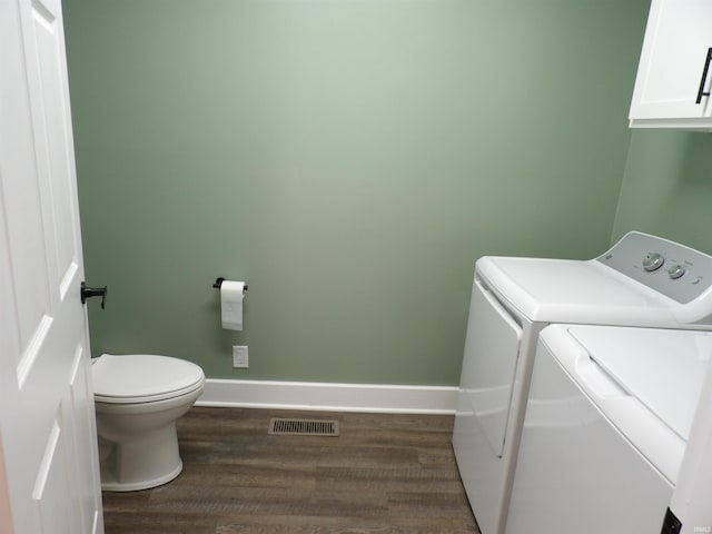 laundry area with laundry area, wood finished floors, visible vents, and washer and dryer