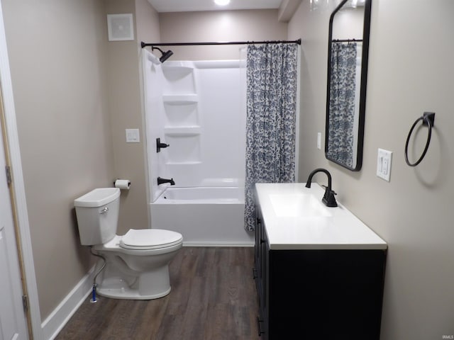 bathroom featuring shower / bath combination with curtain, toilet, wood finished floors, baseboards, and vanity