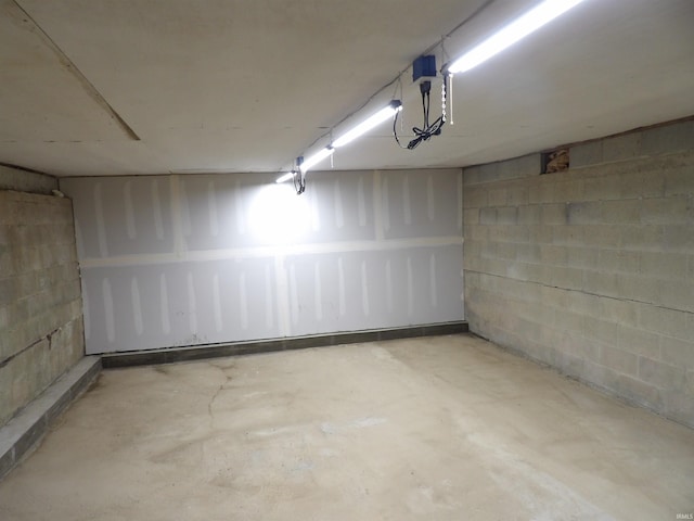 below grade area featuring concrete block wall