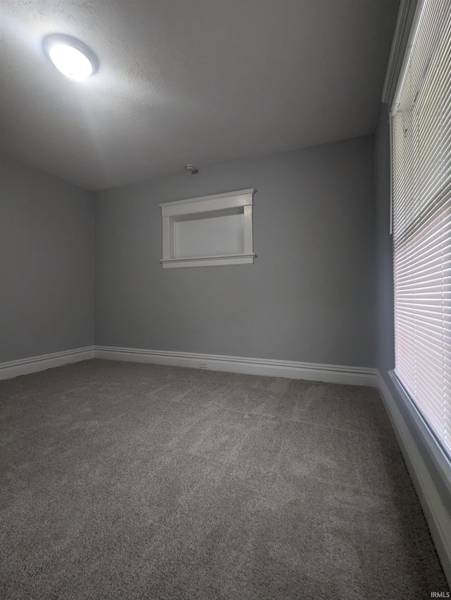 empty room with baseboards and carpet floors