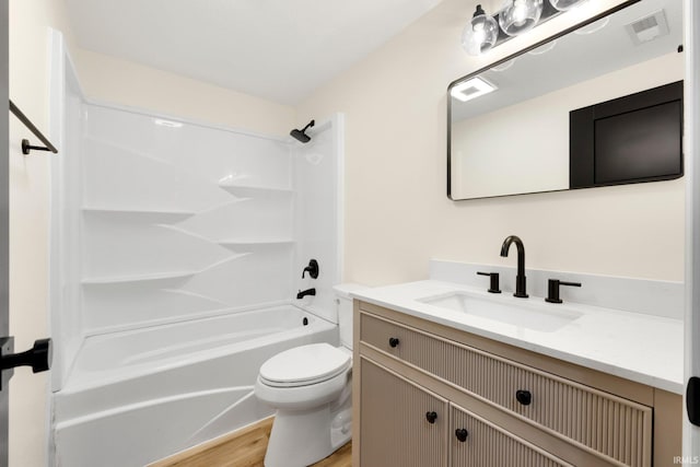 bathroom with toilet, wood finished floors, shower / bath combination, visible vents, and vanity