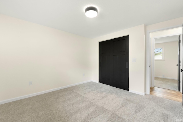unfurnished bedroom featuring carpet and baseboards
