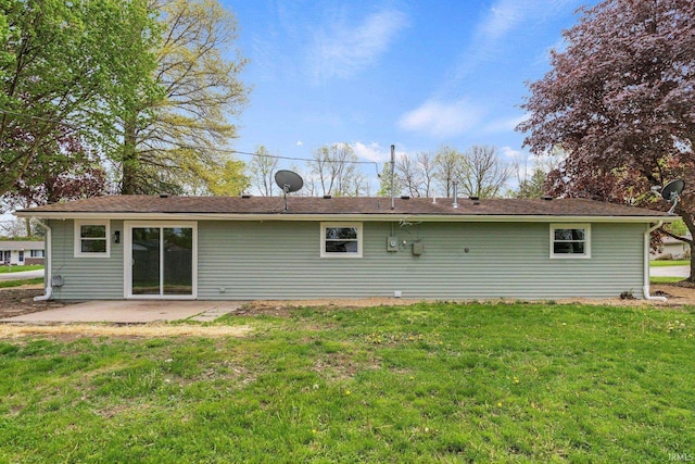 rear view of property with a yard and a patio area
