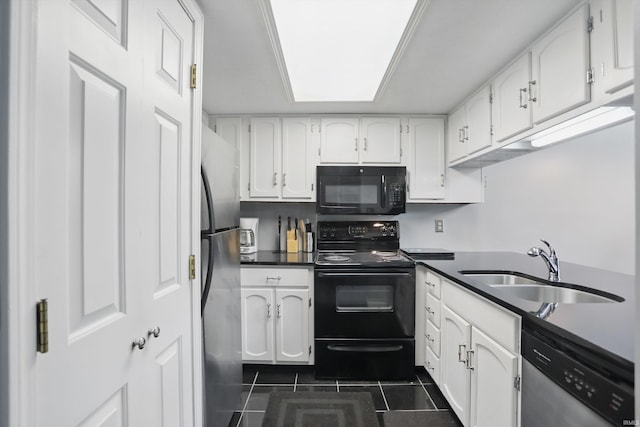 9404 S Lake Ridge Dr, Bloomington, IN 47401 - kitchen with black appliances, white cabinets, and dark tile patterned floors