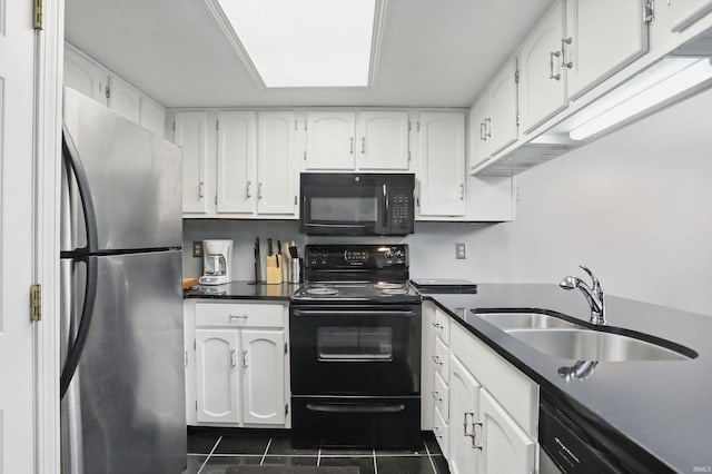 9404 S Lake Ridge Dr, Bloomington, IN 47401 - kitchen featuring dark tile patterned floors, a sink, dark countertops, white cabinets, and black appliances
