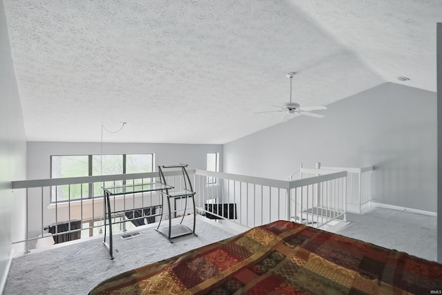9404 S Lake Ridge Dr, Bloomington, IN 47401 - interior space featuring carpet flooring, a ceiling fan, a textured ceiling, baseboards, and vaulted ceiling