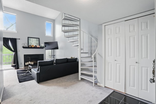 9404 S Lake Ridge Dr, Bloomington, IN 47401 - carpeted living area featuring a fireplace, stairs, a wealth of natural light, and baseboards