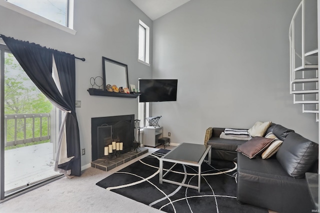 9404 S Lake Ridge Dr, Bloomington, IN 47401 - living room featuring a healthy amount of sunlight, high vaulted ceiling, and a fireplace with raised hearth