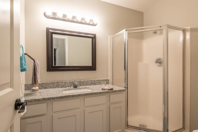 bathroom featuring vanity and a shower stall