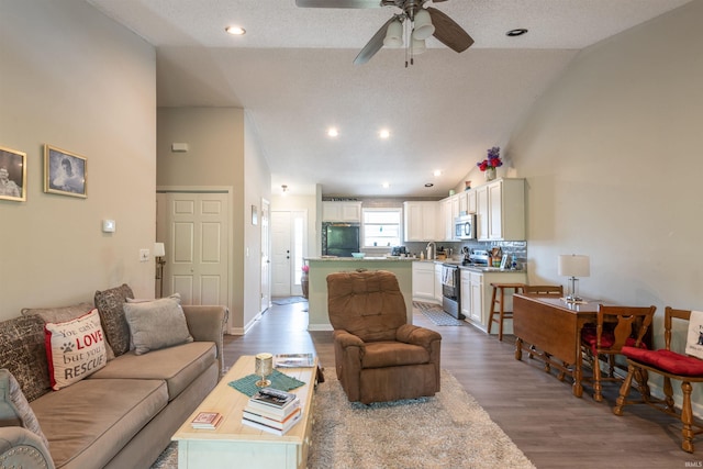 living room featuring high vaulted ceiling, recessed lighting, ceiling fan, and wood finished floors