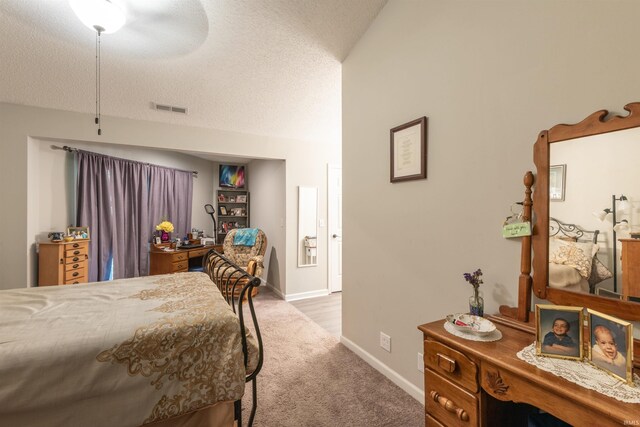 bedroom featuring carpet, a ceiling fan, a textured ceiling, visible vents, and baseboards