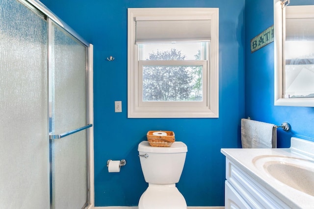 full bathroom with vanity, toilet, and a shower stall