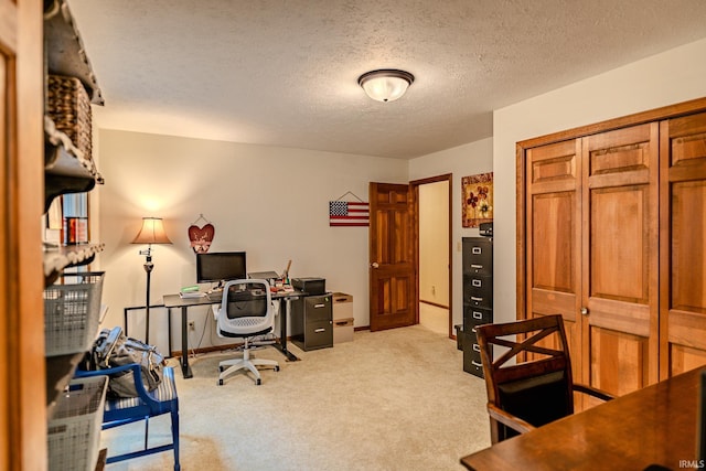 office area featuring light colored carpet and a textured ceiling