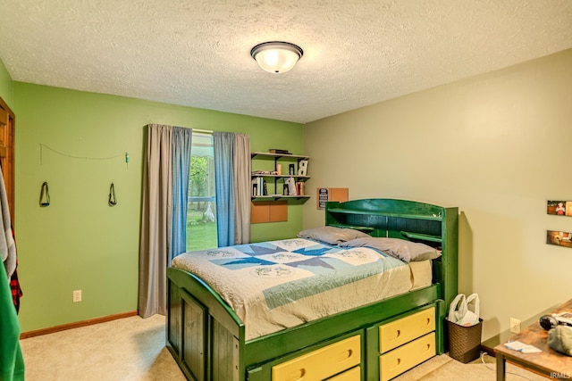 bedroom with light colored carpet, a textured ceiling, and baseboards