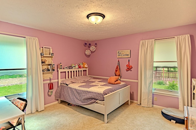 carpeted bedroom with a textured ceiling