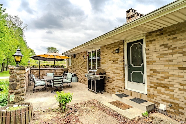 view of patio with grilling area and outdoor dining space
