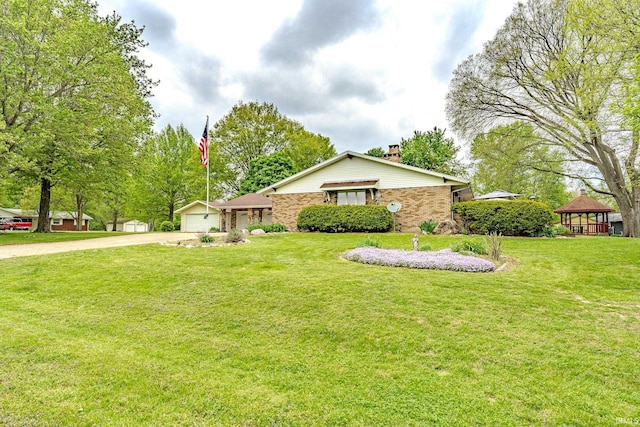ranch-style house with a garage, a chimney, a gazebo, and a front yard