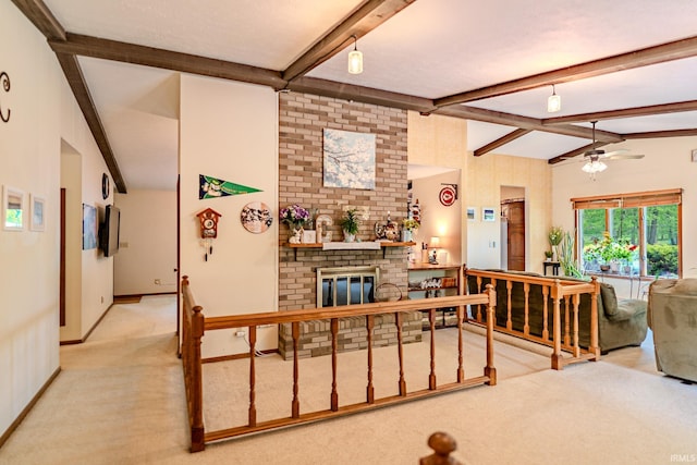 living area with a ceiling fan, baseboards, lofted ceiling with beams, a fireplace, and carpet floors