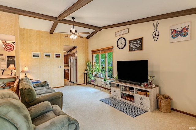carpeted living room with baseboards, a ceiling fan, and vaulted ceiling with beams