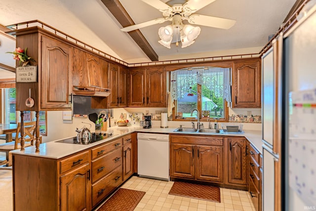 kitchen featuring a sink, plenty of natural light, white dishwasher, black electric cooktop, and vaulted ceiling with beams