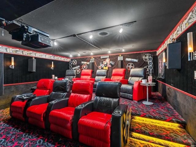 home theater with rail lighting and carpet flooring