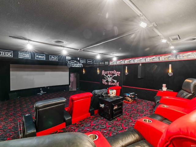 home theater with rail lighting, a textured ceiling, and carpet floors
