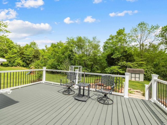 deck with a yard, an outbuilding, and a storage shed