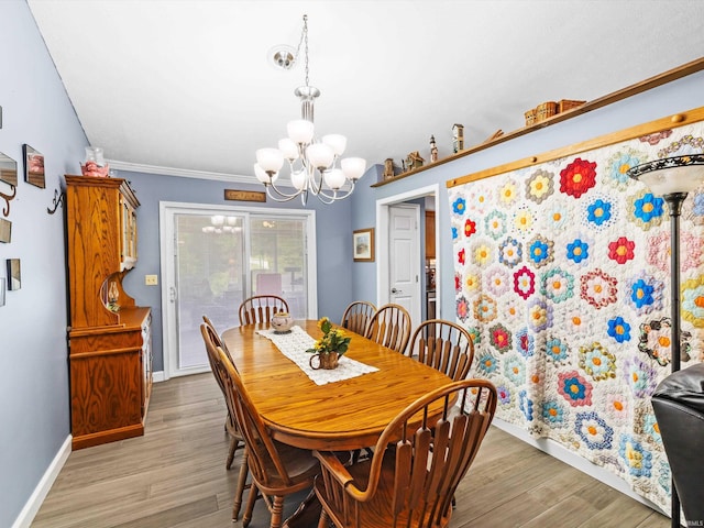 dining area featuring baseboards, a notable chandelier, and light wood-style flooring