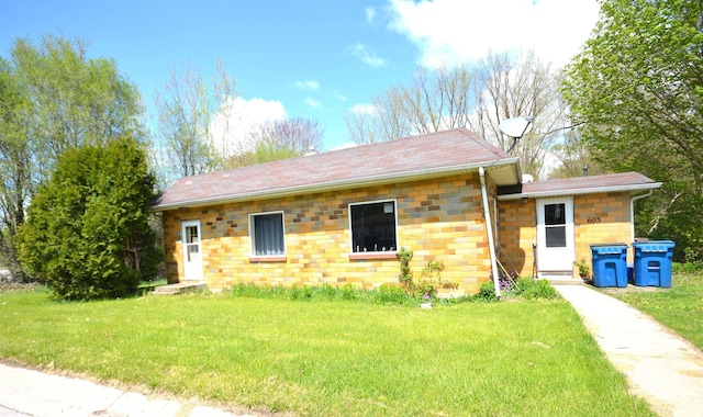 view of front of house featuring stone siding and a front lawn