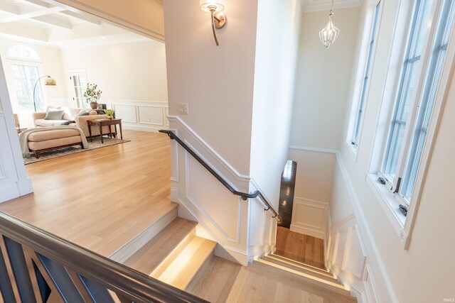 9225 S Foggy Ridge Ln, Bloomington, IN 47401 - staircase with crown molding, wood finished floors, a decorative wall, and beamed ceiling