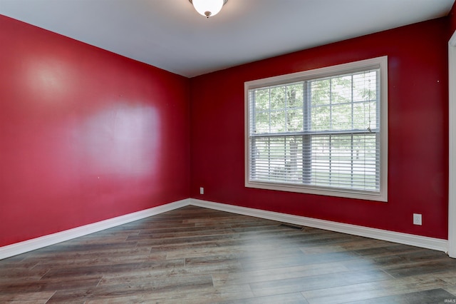 918 S December 25th Ln, Santa Claus, IN 47579 - empty room with wood finished floors, visible vents, baseboards, and a healthy amount of sunlight