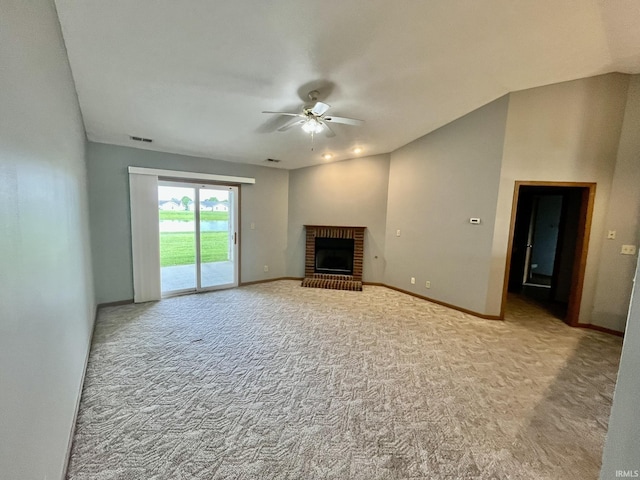 unfurnished living room with a brick fireplace, carpet floors, visible vents, baseboards, and ceiling fan