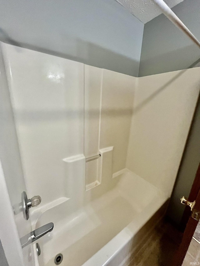full bathroom featuring a shower and a washtub