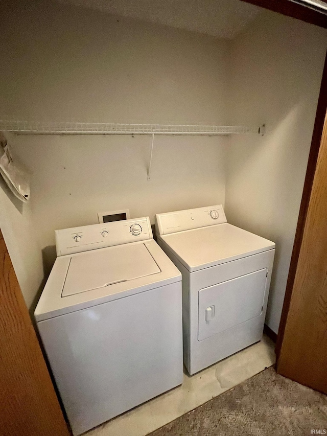 washroom with washing machine and clothes dryer and laundry area