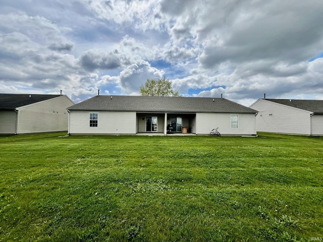 back of house featuring a yard and a patio area