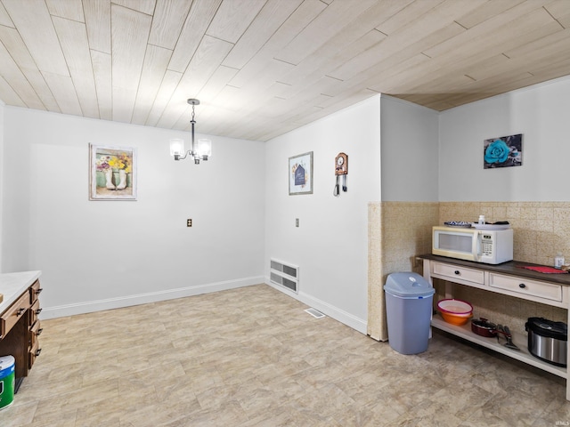 dining room with an inviting chandelier, visible vents, and wood ceiling