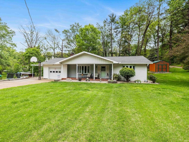 ranch-style home featuring covered porch, a storage shed, a garage, a front lawn, and driveway
