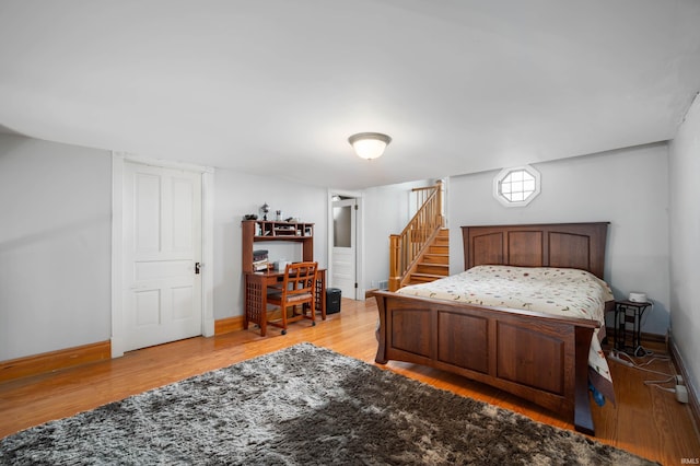 bedroom with light wood finished floors and baseboards