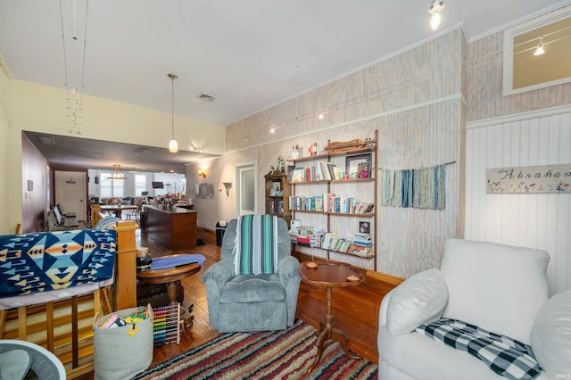 living room with visible vents and wood finished floors