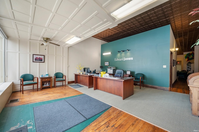 office with ceiling fan, baseboards, hardwood / wood-style floors, and visible vents