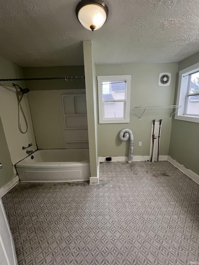 712 E Water St, Portland, IN 47371 - full bath with a textured ceiling, shower / bathtub combination, baseboards, and visible vents