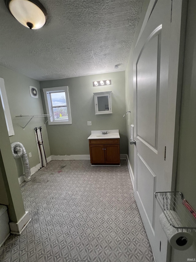 712 E Water St, Portland, IN 47371 - bathroom with baseboards, vanity, and a textured ceiling