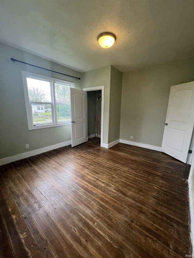 712 E Water St, Portland, IN 47371 - unfurnished bedroom featuring dark wood-style flooring and baseboards