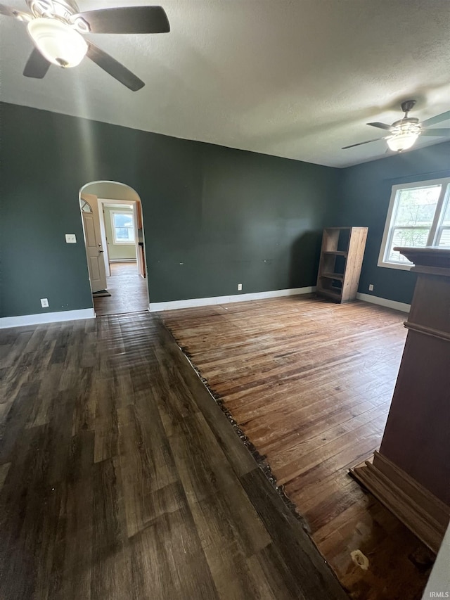 712 E Water St, Portland, IN 47371 - unfurnished living room with wood finished floors, ceiling fan, and arched walkways