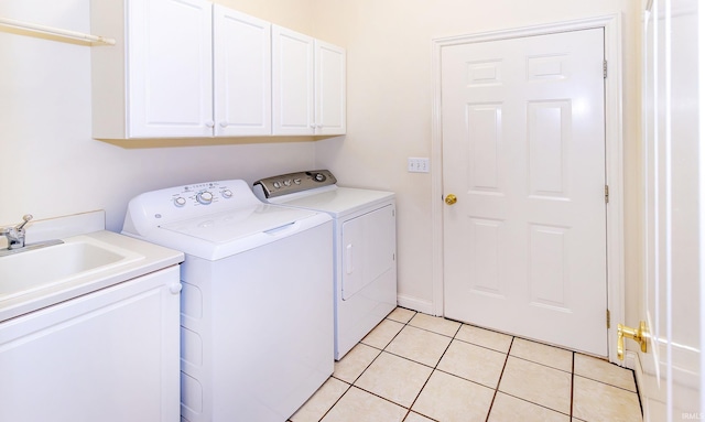 laundry area with cabinet space, washer and clothes dryer, and light tile patterned floors