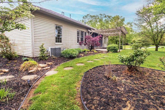 exterior space with a pergola, a yard, and central AC unit