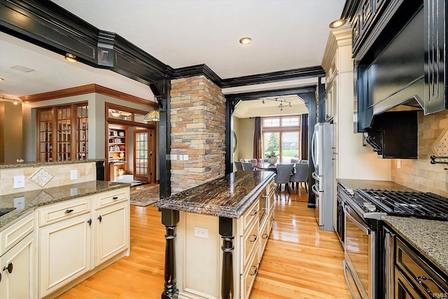4052 Diamond Row, Greenwood, IN 46143 - kitchen with ornamental molding, stainless steel appliances, dark stone countertops, and light wood-style floors