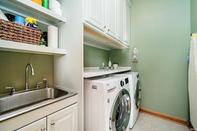 4052 Diamond Row, Greenwood, IN 46143 - washroom with a sink, cabinet space, light tile patterned flooring, washing machine and clothes dryer, and baseboards