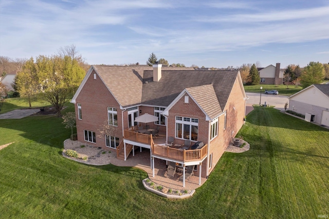 4052 Diamond Row, Greenwood, IN 46143 - back of property featuring a chimney, a deck, brick siding, and a lawn