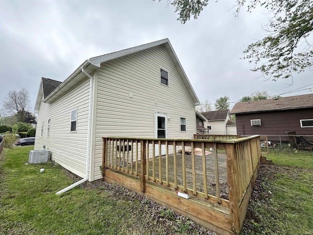 rear view of house featuring central AC, a deck, a yard, and fence